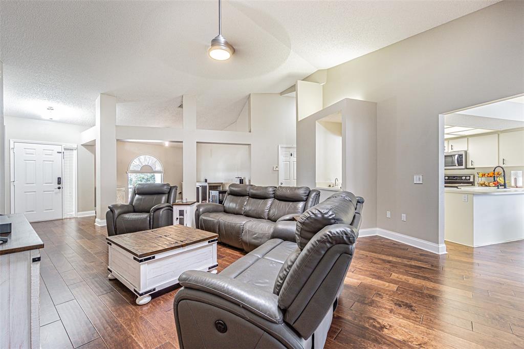 7708 Merrily Way Lakeland, FL 33809 - Photo 8 of 41 a living room with furniture and wooden floor