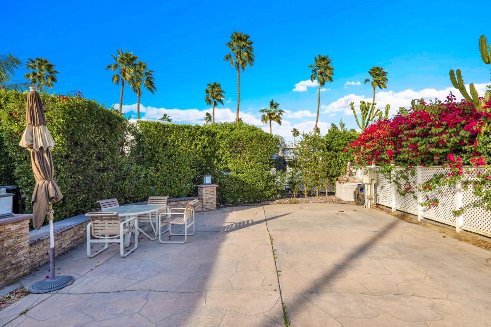 69411 Ramon Road, Unit 362 Cathedral City, CA 92234 - Photo 2 of 13 a view of a patio with table and chairs and potted plants