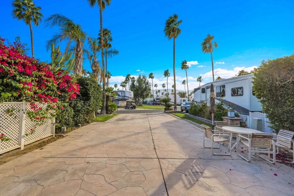 69411 Ramon Road, Unit 362 Cathedral City, CA 92234 - Photo 3 of 13 a view of a patio with a table and chairs and potted plants