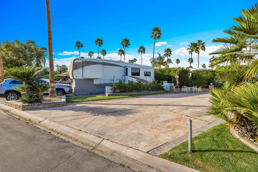 69411 Ramon Road, Unit 362 Cathedral City, CA 92234 - Photo 6 of 13 a view of a white house with a yard and plants