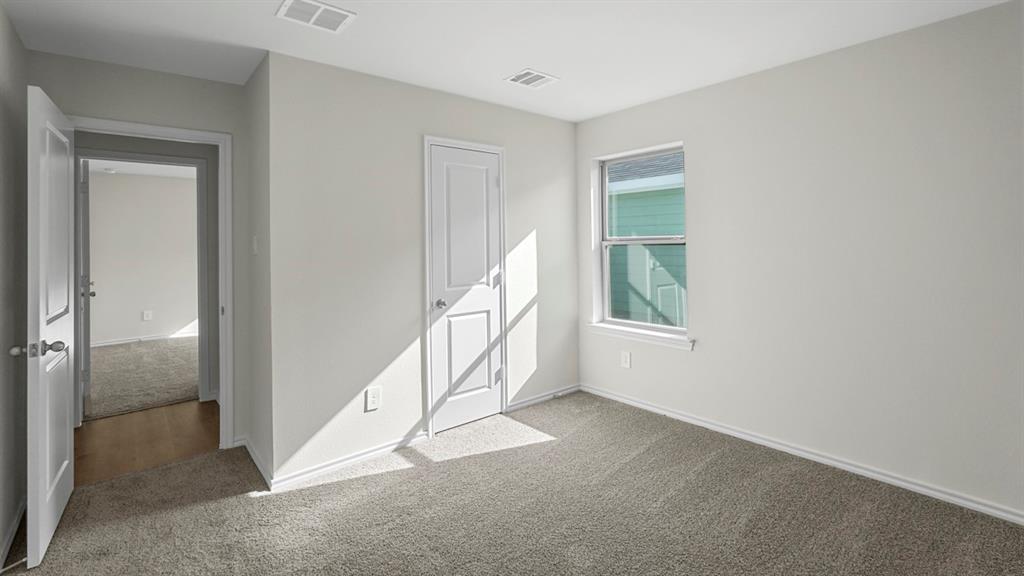 1953 Freeman Street Tyler, TX 75704 - Photo 24 of 32 Light-filled room featuring neutral wall paint, gray carpeting, a double-hung window, and white trim