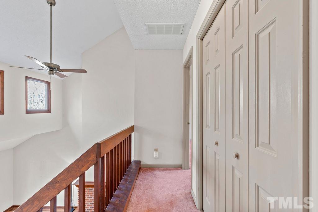 1014 Boathouse Court Raleigh, NC 27615 - Photo 18 of 41 a view of a hallway with a white walls and stairs