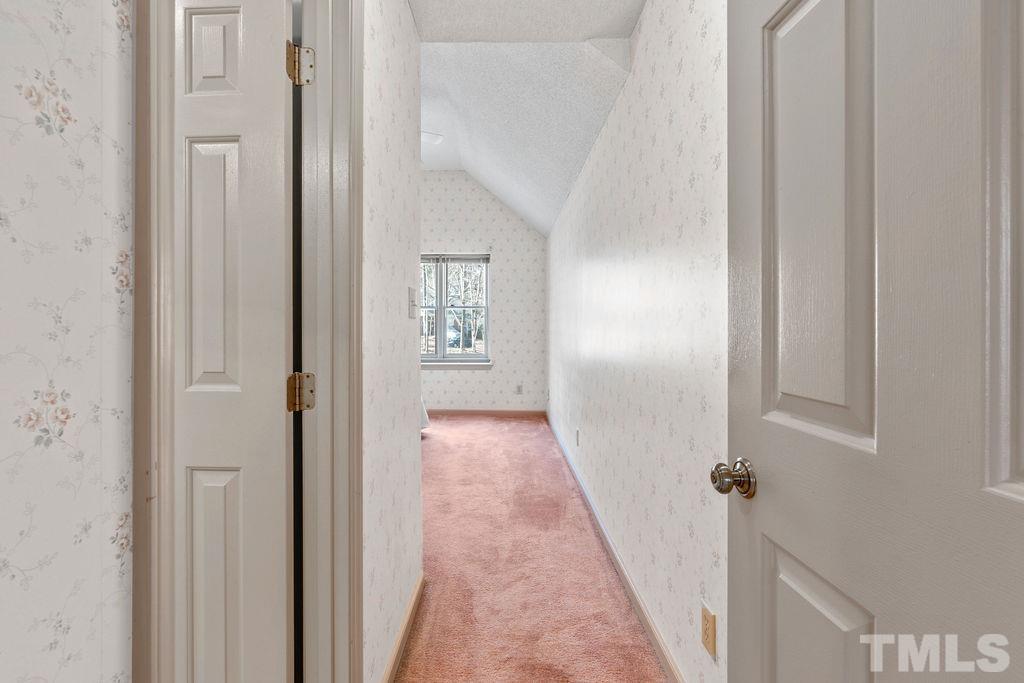 1014 Boathouse Court Raleigh, NC 27615 - Photo 26 of 41 a view of a hallway with wooden floor and a bathroom