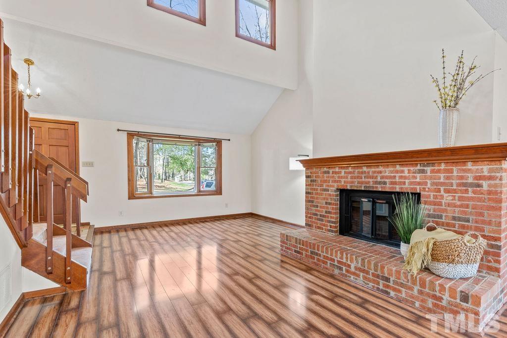 1014 Boathouse Court Raleigh, NC 27615 - Photo 8 of 41 wooden floor fireplace and windows in a room