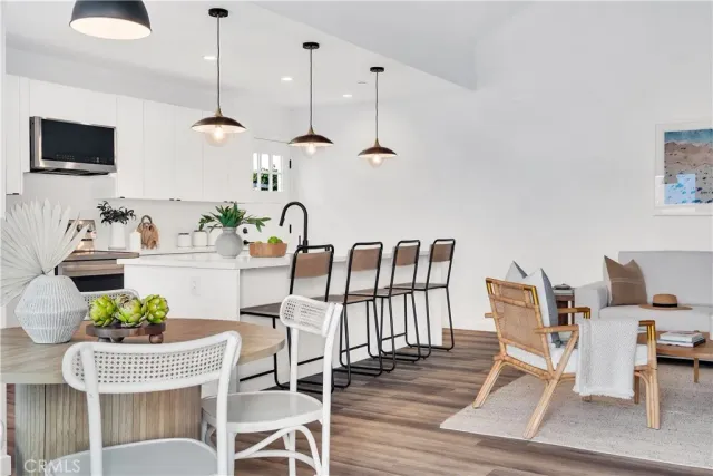 a dining room with furniture a rug and wooden floor