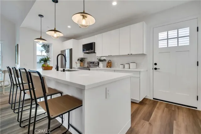 a view of kitchen with sink dining table and chairs