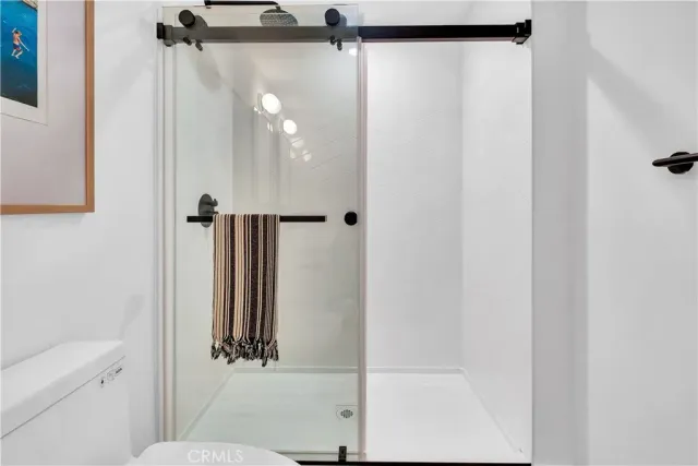 a bathroom with a shower and a mirror