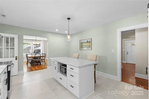 a room with a stove and a chandelier