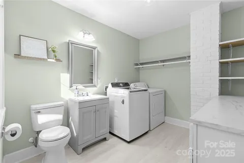 a view of bathroom with a toilet sink and mirror