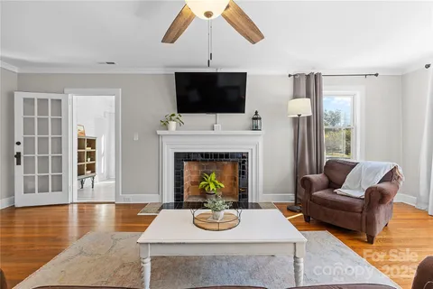 a living room with furniture fireplace and flat screen tv