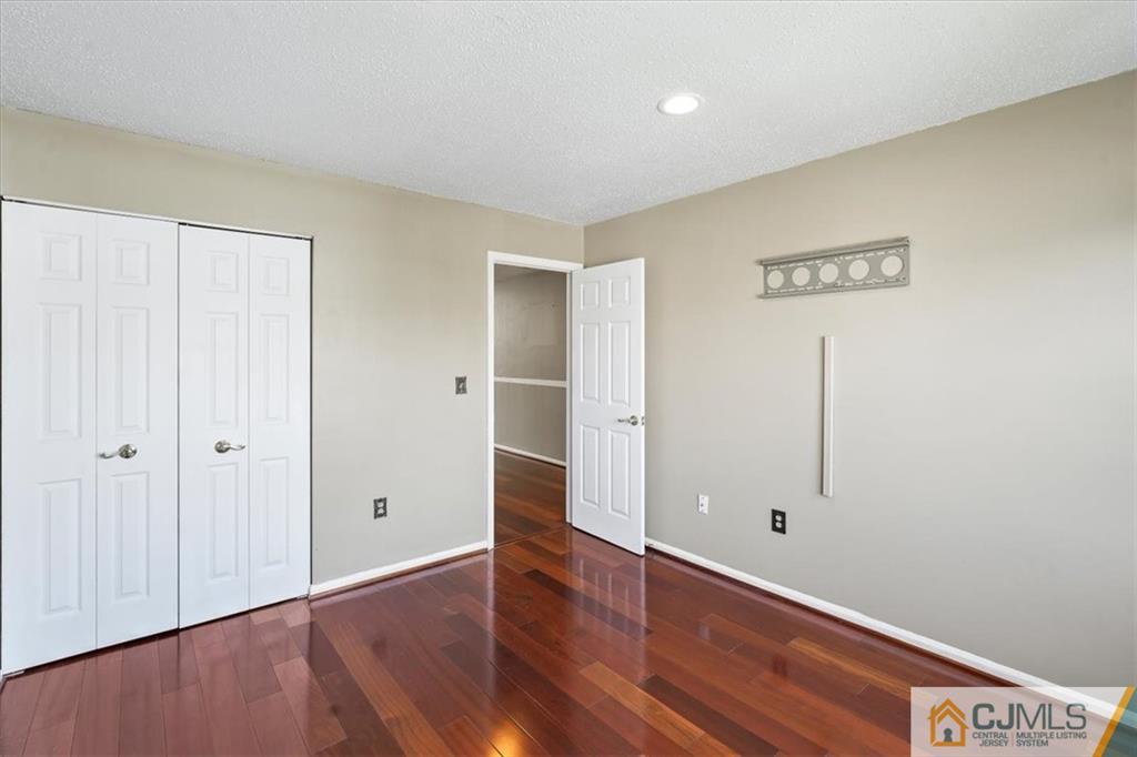 834 Edpas Road, Unit 834 New Brunswick, NJ 08901 - Photo 11 of 20 a view of an empty room with wooden floor