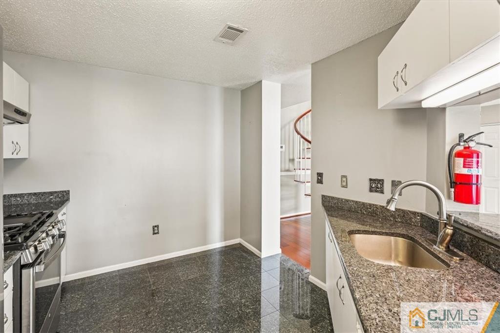 834 Edpas Road, Unit 834 New Brunswick, NJ 08901 - Photo 9 of 20 a kitchen with a sink and a refrigerator