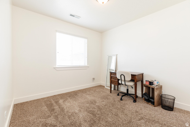 1145 West 2640th Street South Logan, UT 84321 - Photo 10 of 17 Carpeted room featuring a single window with blinds, white walls, and bright overhead lighting