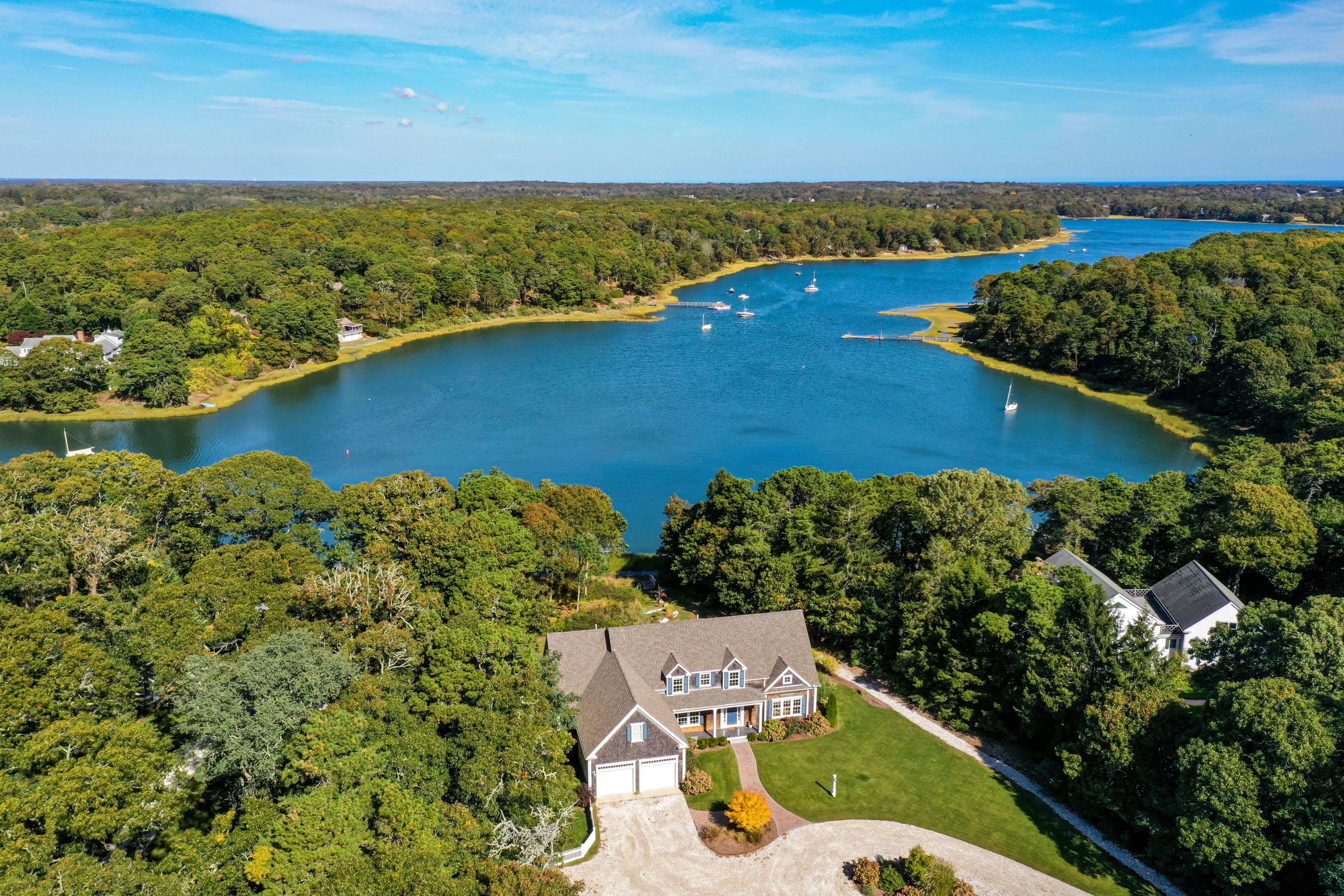 134 Namequoit Road Orleans, MA 02653 - Photo 1 of 69 an aerial view of a house with a lake view