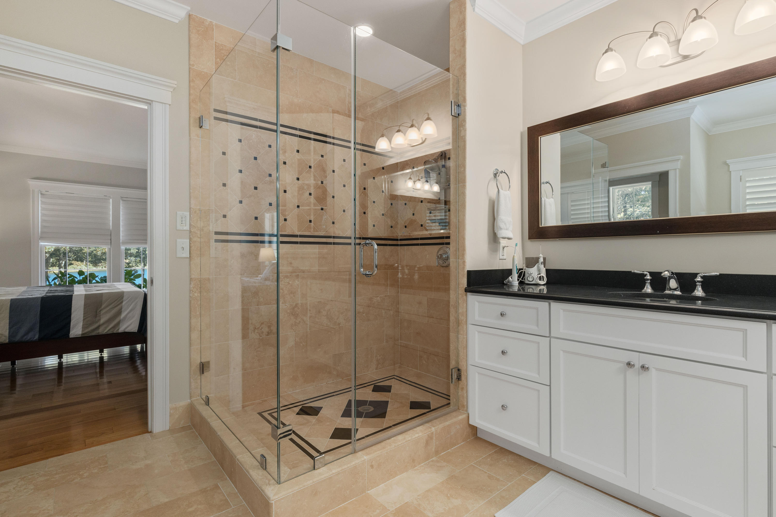 134 Namequoit Road Orleans, MA 02653 - Photo 30 of 69 a bathroom with a shower sink and mirror