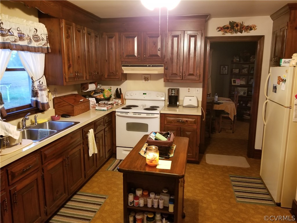 14500 Reed Rock Road Amelia Court House, VA 23002 - Photo 24 of 37 a kitchen with wooden cabinets and refrigerator