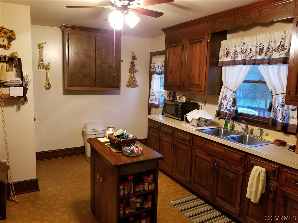 14500 Reed Rock Road Amelia Court House, VA 23002 - Photo 25 of 37 a kitchen with stainless steel appliances a sink stove and cabinets