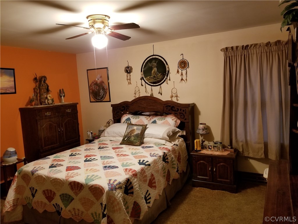 14500 Reed Rock Road Amelia Court House, VA 23002 - Photo 36 of 37 a bedroom with a bed and a chandelier