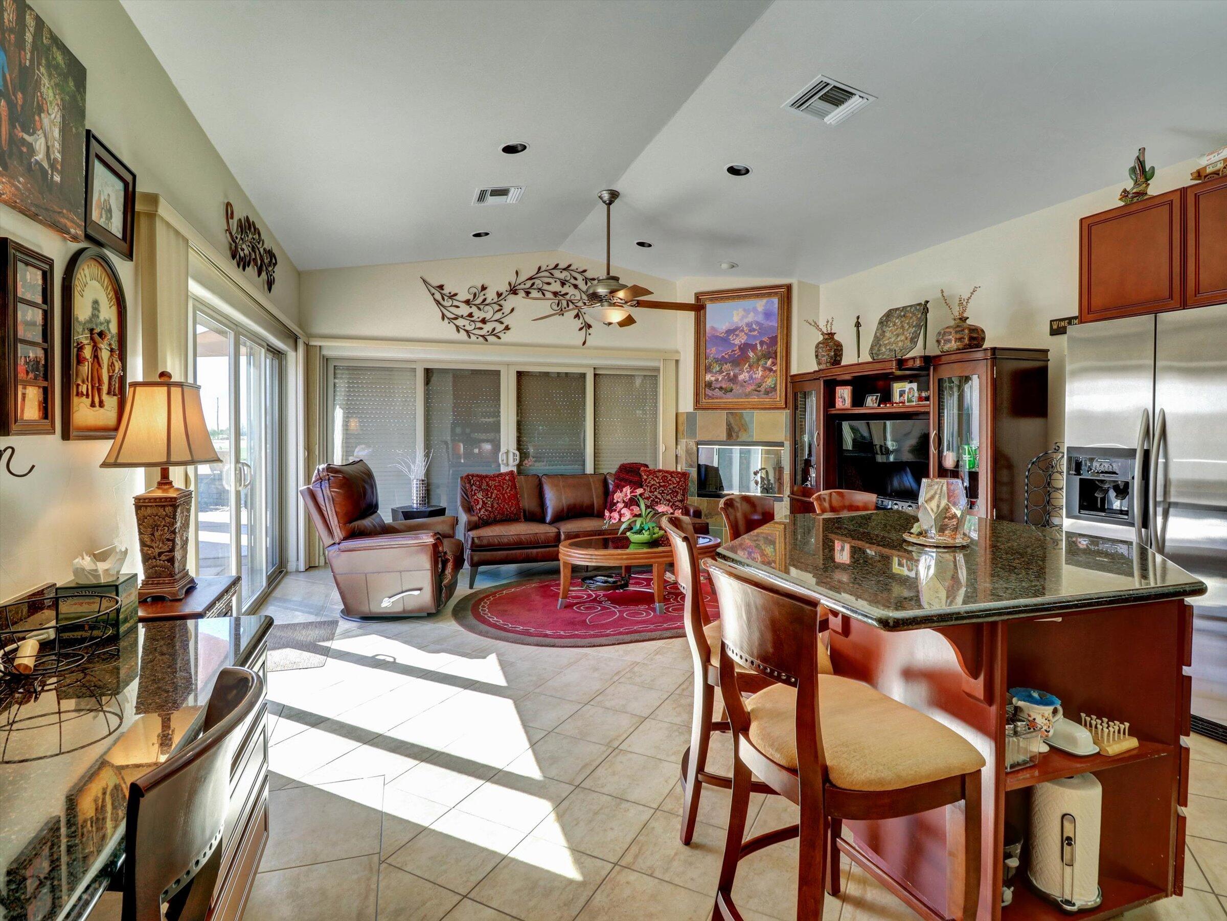 86113 Sonoma Creek Road Coachella, CA 92236 - Photo 14 of 55 a living room with furniture a chandelier and a dining table