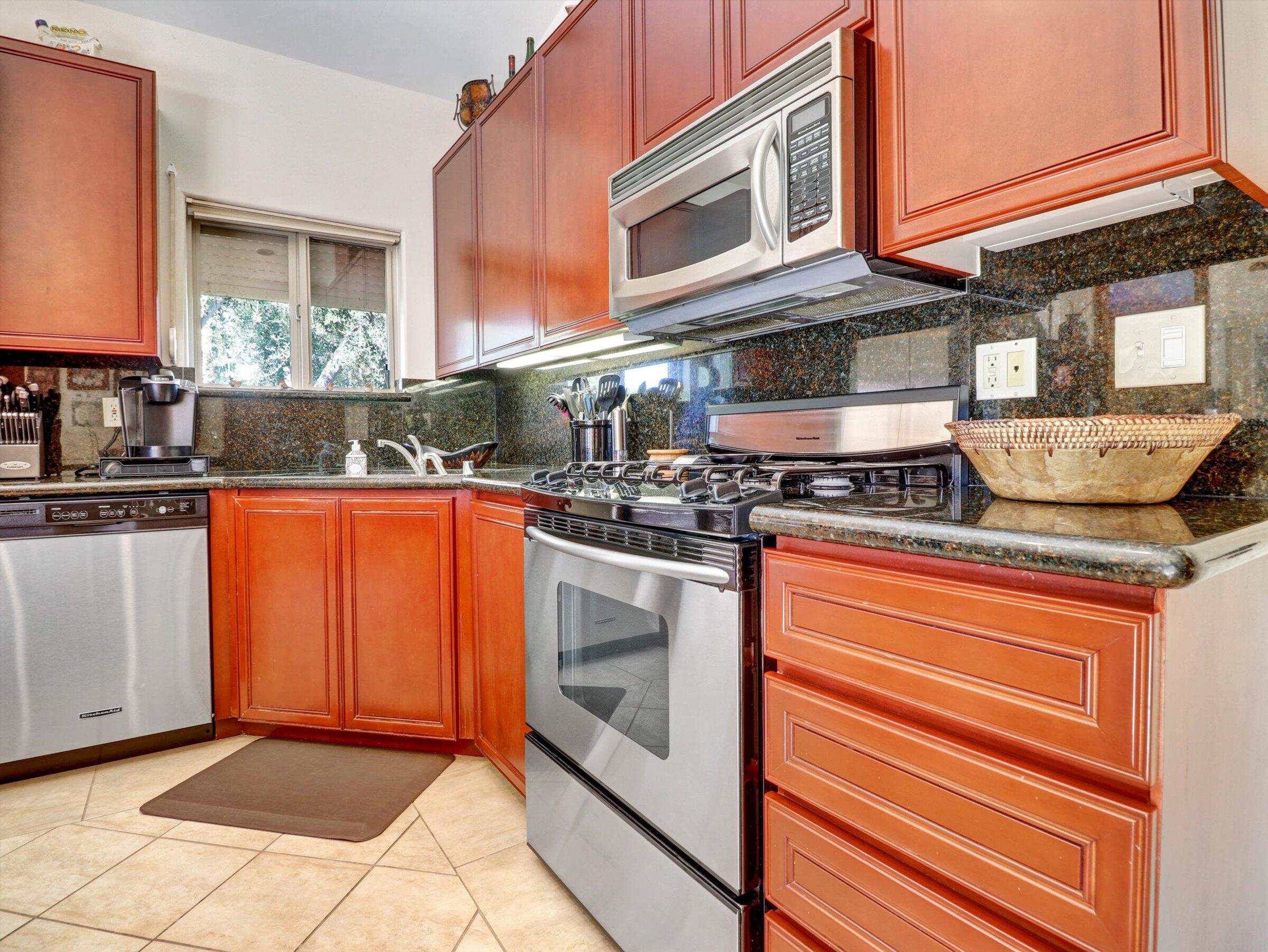 86113 Sonoma Creek Road Coachella, CA 92236 - Photo 15 of 55 a kitchen with stainless steel appliances granite countertop a stove and a microwave
