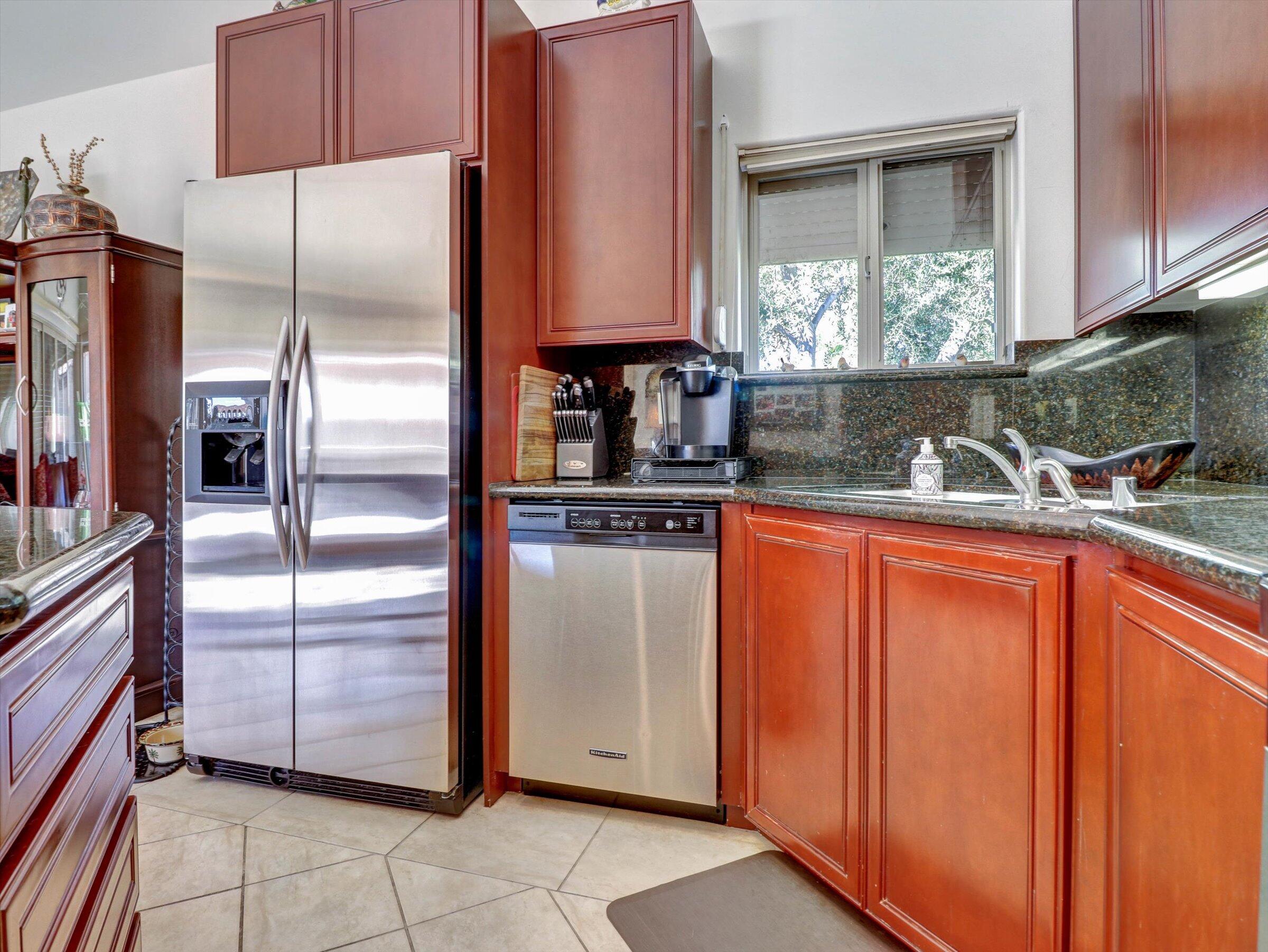 86113 Sonoma Creek Road Coachella, CA 92236 - Photo 16 of 55 a kitchen with stainless steel appliances granite countertop a refrigerator and a sink