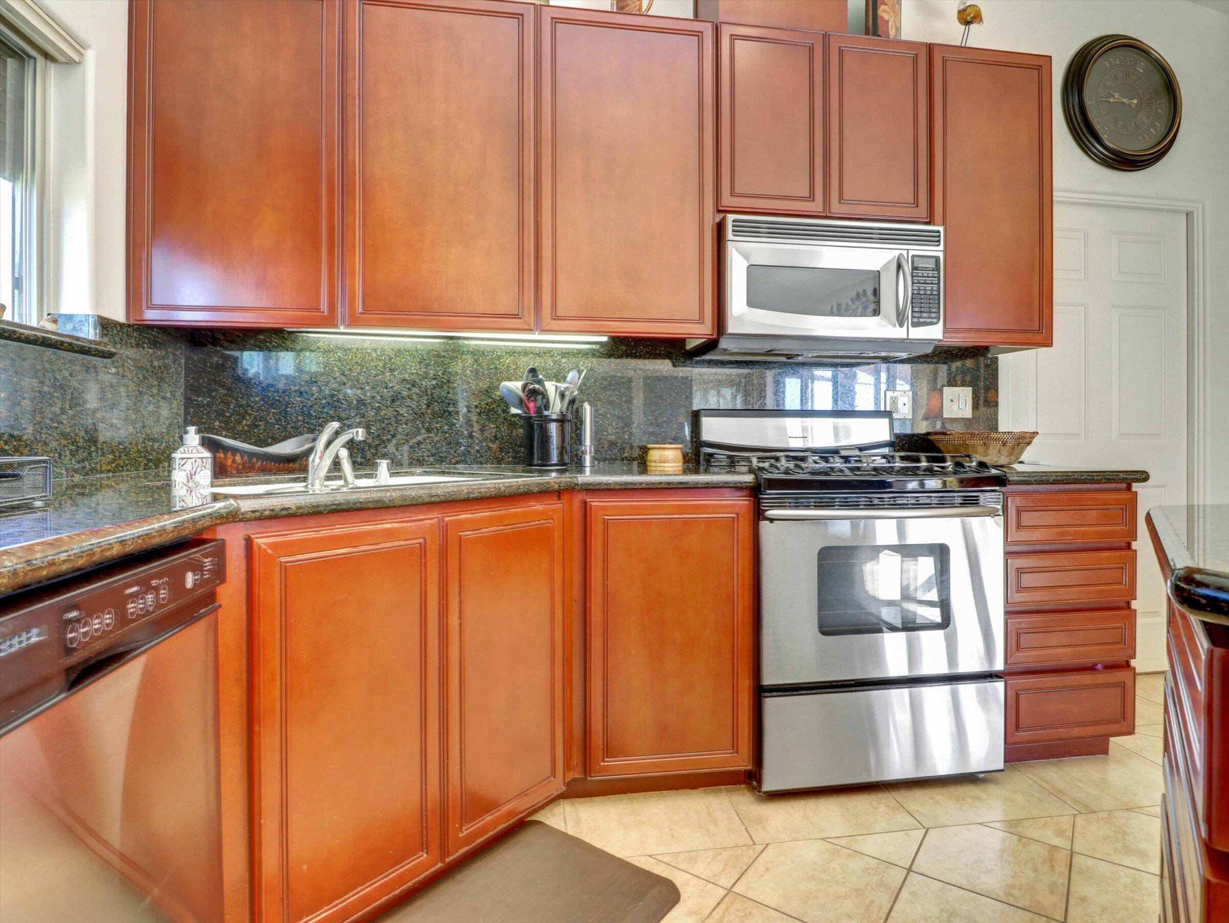 86113 Sonoma Creek Road Coachella, CA 92236 - Photo 17 of 55 a kitchen with stainless steel appliances granite countertop a stove and a microwave