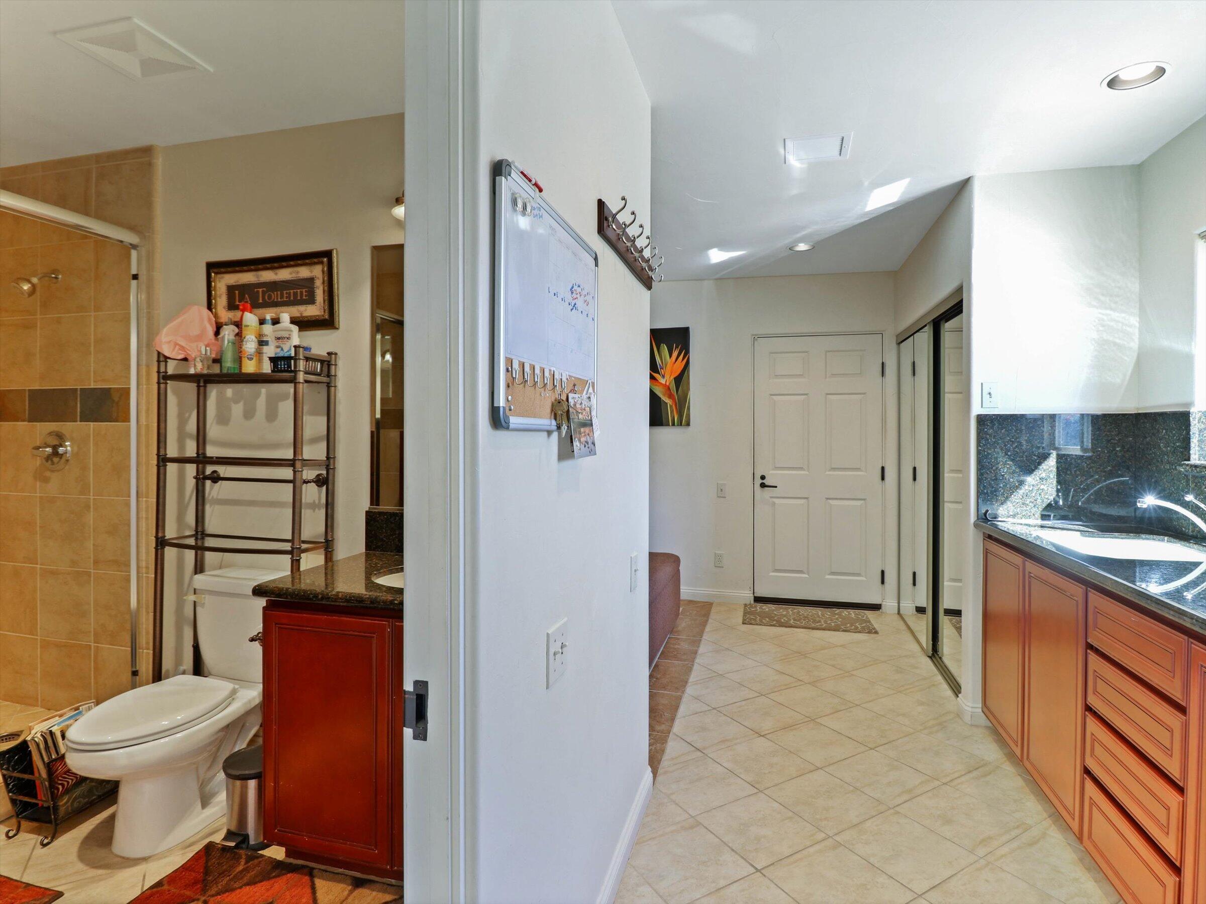 86113 Sonoma Creek Road Coachella, CA 92236 - Photo 18 of 55 a bathroom with a toilet sink shower and mirror