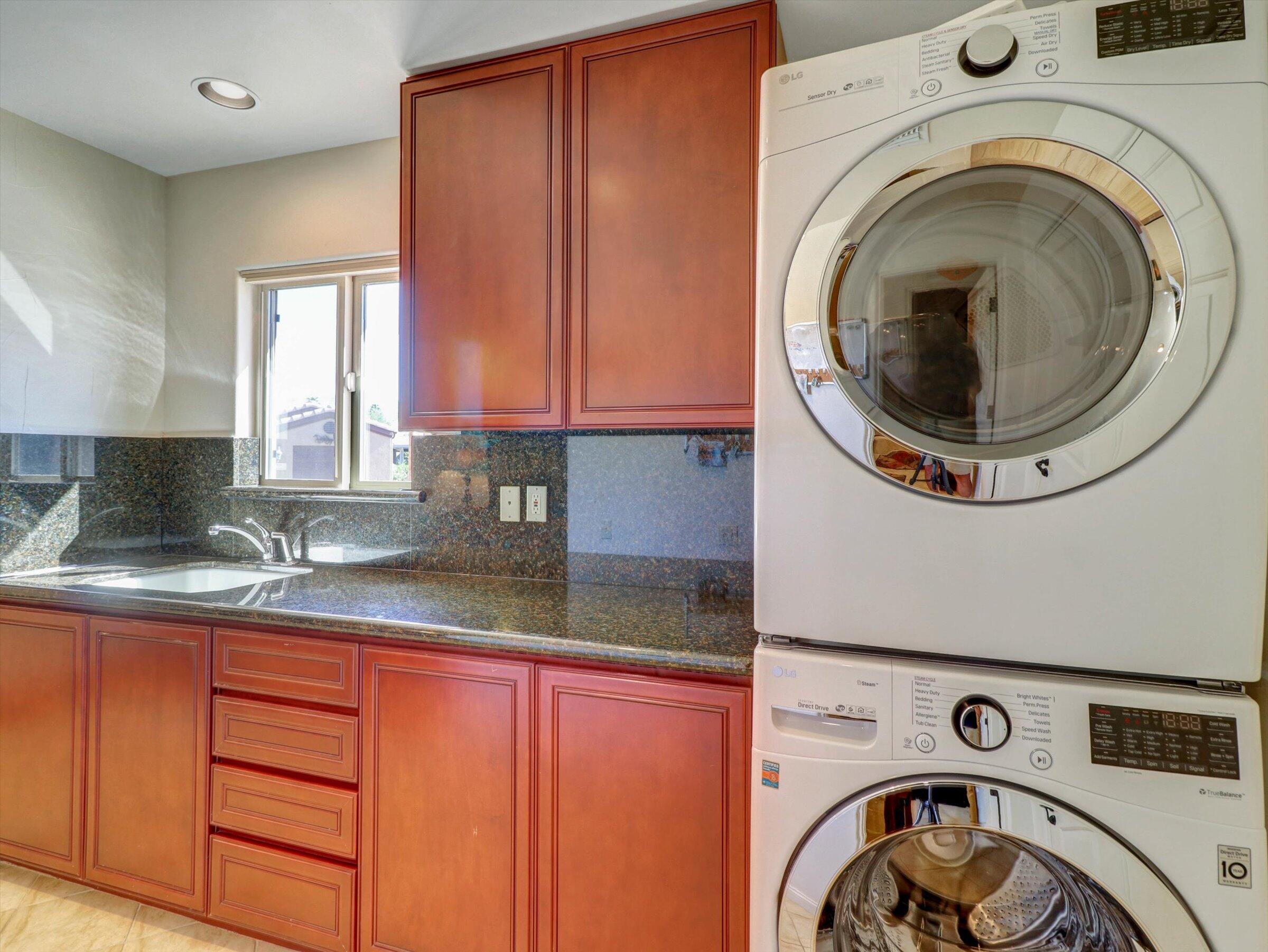 86113 Sonoma Creek Road Coachella, CA 92236 - Photo 19 of 55 a bathroom with a sink a washer and dryer