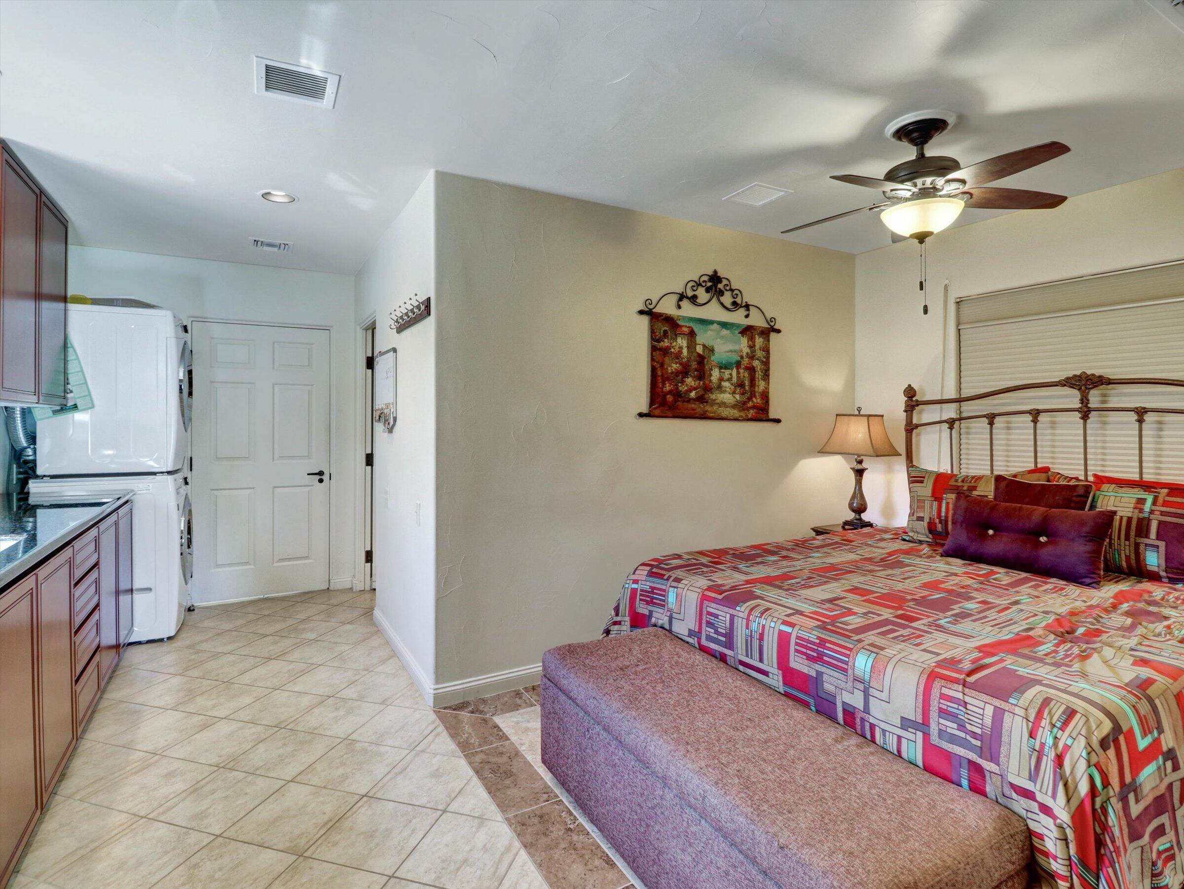 86113 Sonoma Creek Road Coachella, CA 92236 - Photo 23 of 55 a bedroom with a large bed and a chandelier