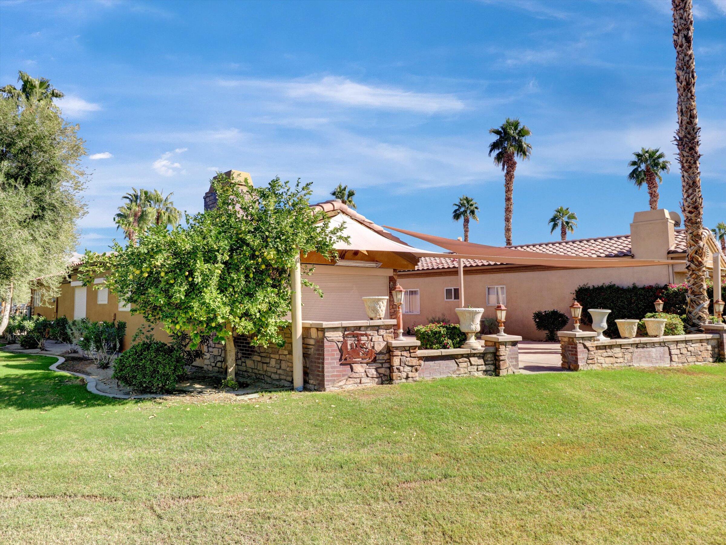 86113 Sonoma Creek Road Coachella, CA 92236 - Photo 30 of 55 a view of a patio with table and chairs potted plants and palm tree