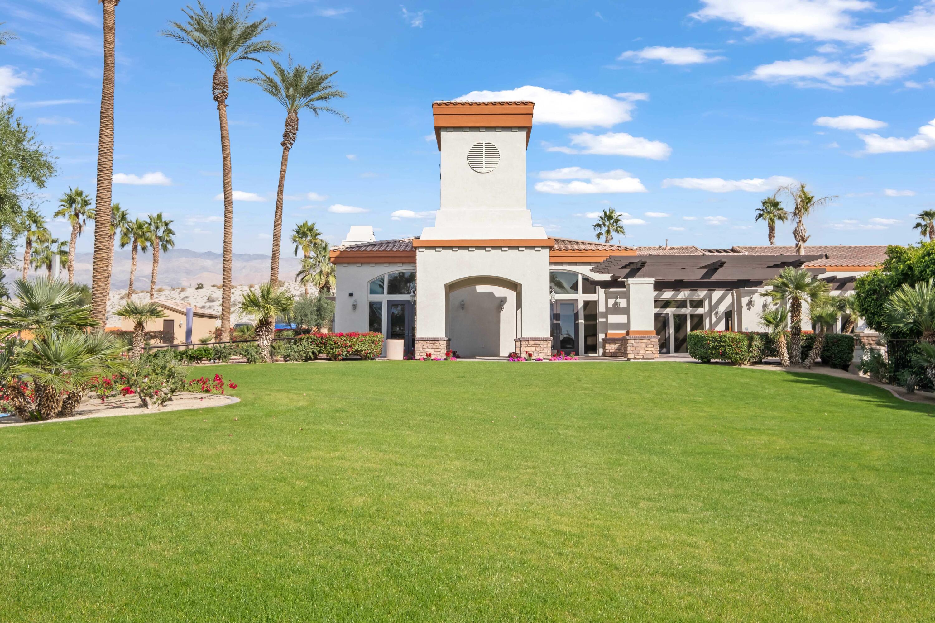 86113 Sonoma Creek Road Coachella, CA 92236 - Photo 38 of 55 a view of a white house with a big yard and palm trees