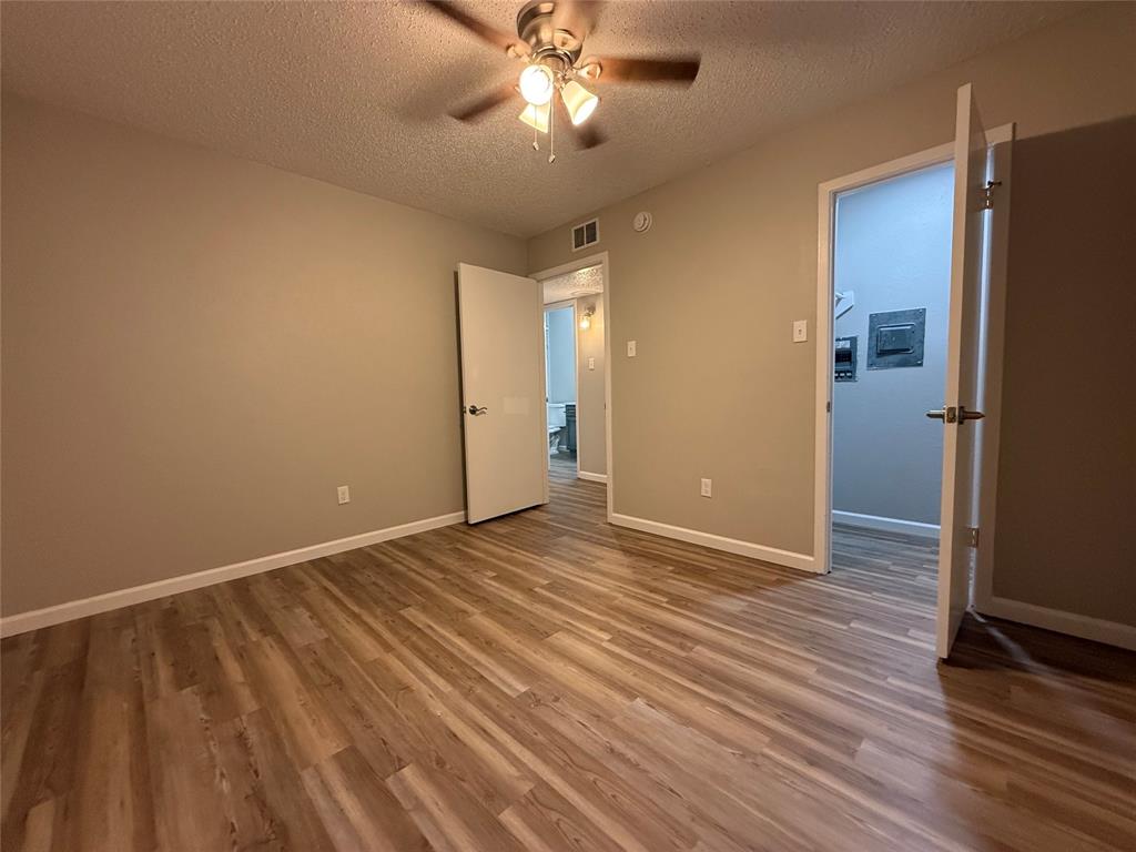 629 Central Avenue, Unit 202 Newark, TX 76071 - Photo 17 of 19 wooden floor in an empty room with a window