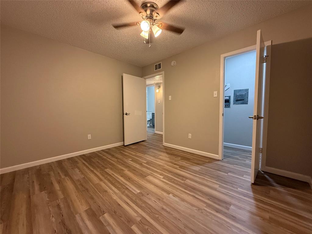 629 Central Avenue, Unit 202 Newark, TX 76071 - Photo 18 of 19 a view of an empty room with wooden floor