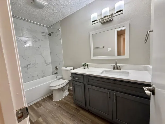 a bathroom with a double vanity sink toilet and shower