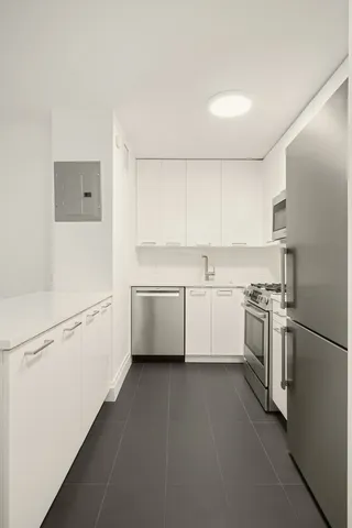 a kitchen with a white cabinets and white appliances