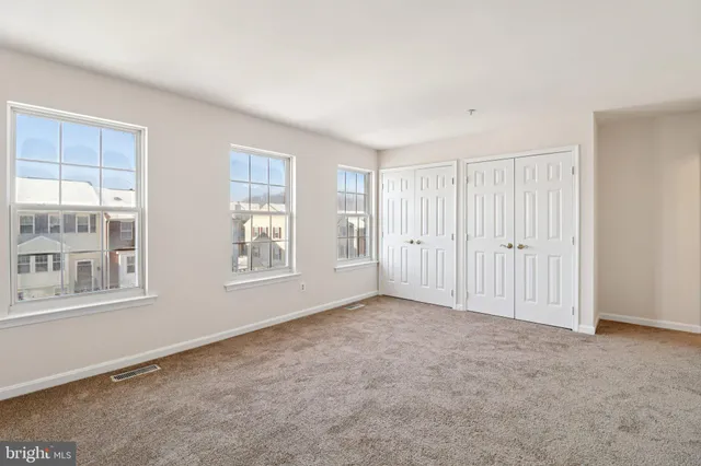 a view of an empty room with closet area