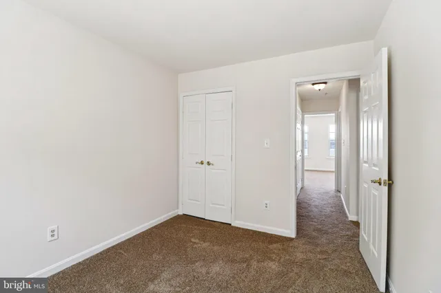 a view of a building with a bench in front of house