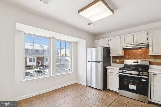 a refrigerator freezer sitting inside of a kitchen