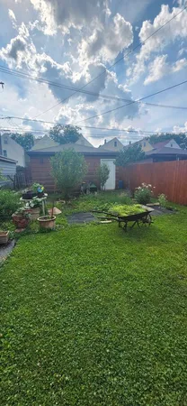 a view of a backyard with table and chairs and potted plants