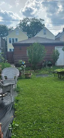 a view of a brick house with a yard