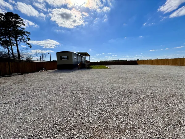 a view of car parked in middle of yard
