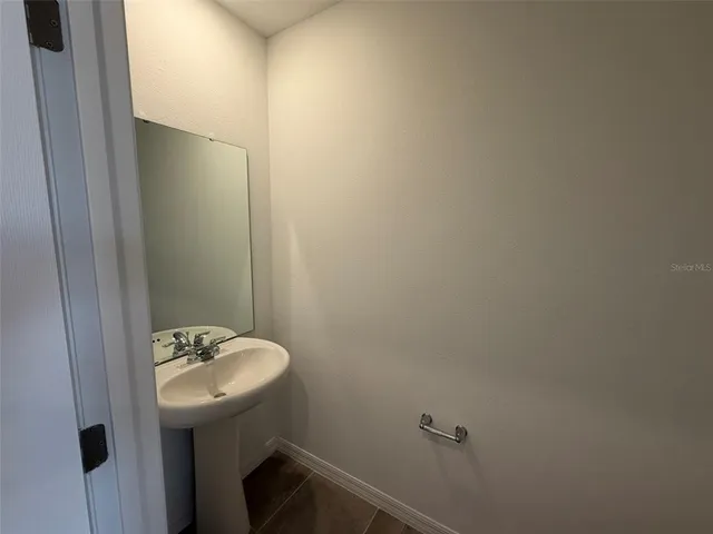 a bathroom with a sink and mirror