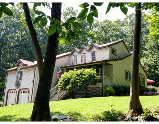 a view of a house with a tree in the yard