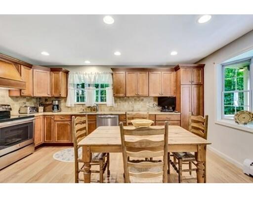 6 Stone Ridge Drive Leicester, MA 01524 - Photo 5 of 30 a kitchen with a table chairs microwave and cabinets