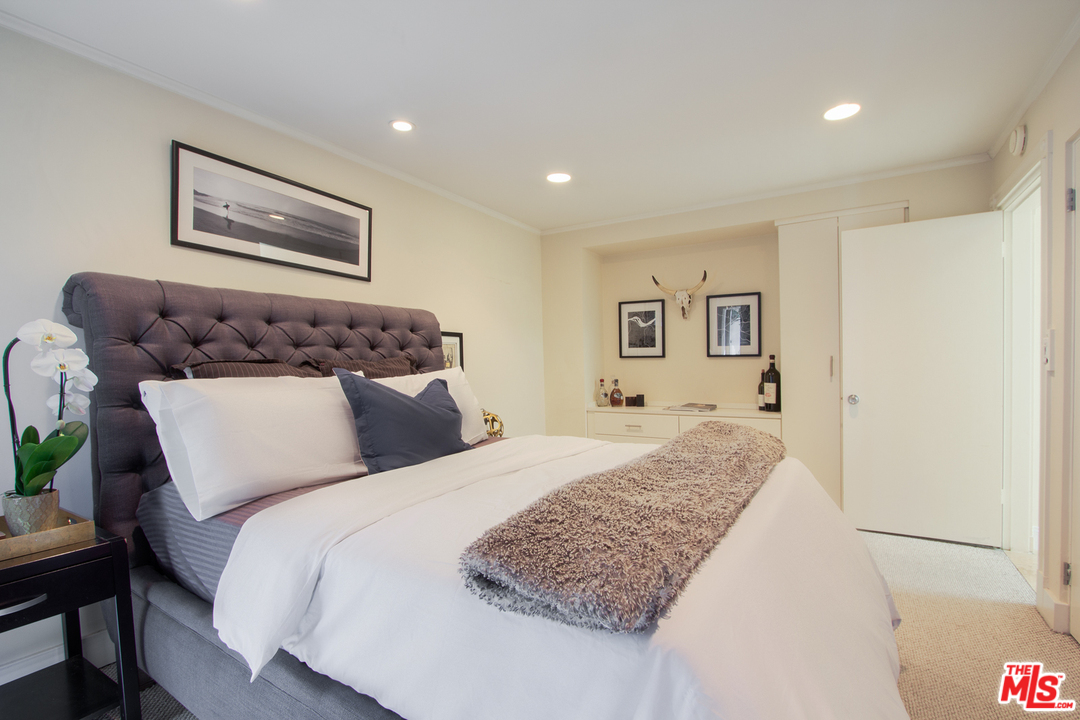 2267 Roscomare Road Los Angeles, CA 90077 - Photo 12 of 31 a bedroom with a large bed and a couch