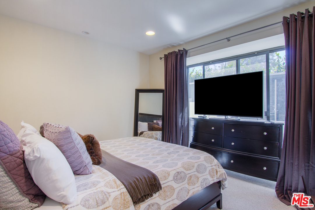 2267 Roscomare Road Los Angeles, CA 90077 - Photo 14 of 31 a bedroom with a bed and a flat screen tv