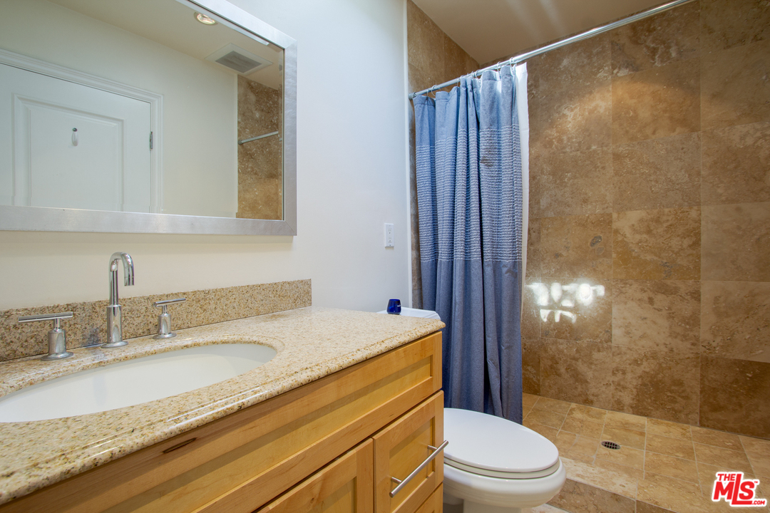 2267 Roscomare Road Los Angeles, CA 90077 - Photo 18 of 31 a bathroom with a granite countertop sink toilet and shower
