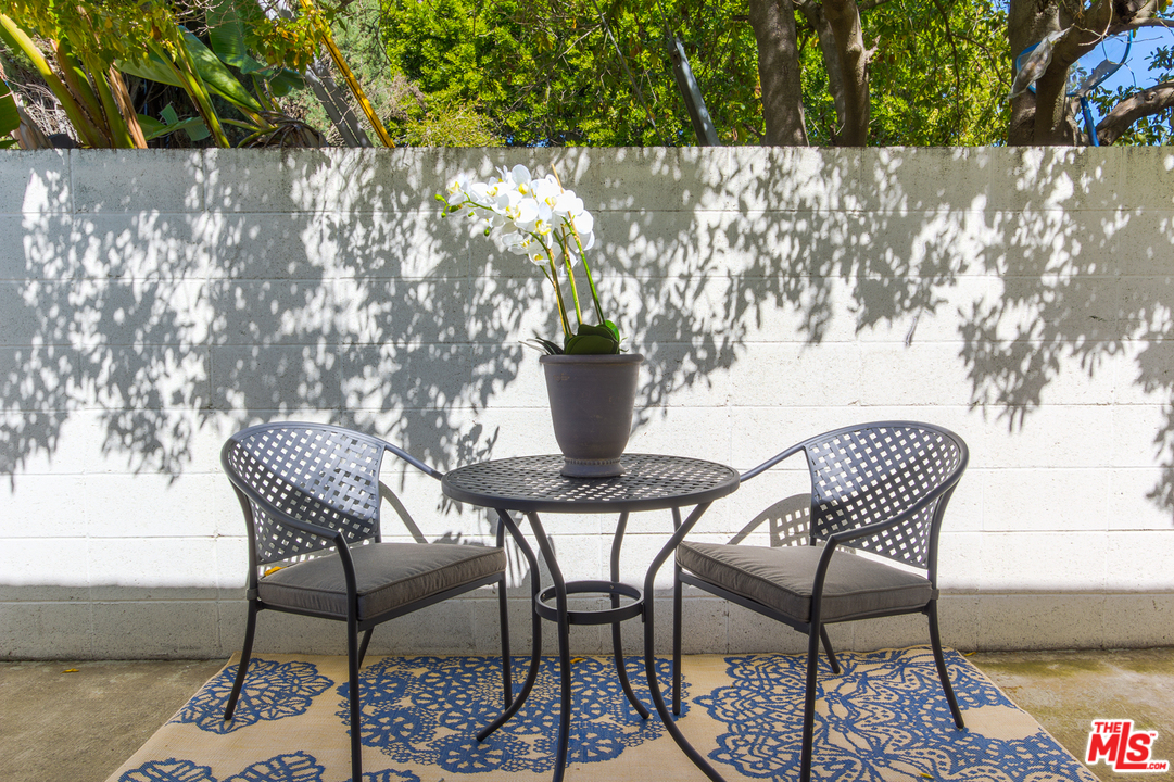 2267 Roscomare Road Los Angeles, CA 90077 - Photo 19 of 31 a view of a chairs and table in patio