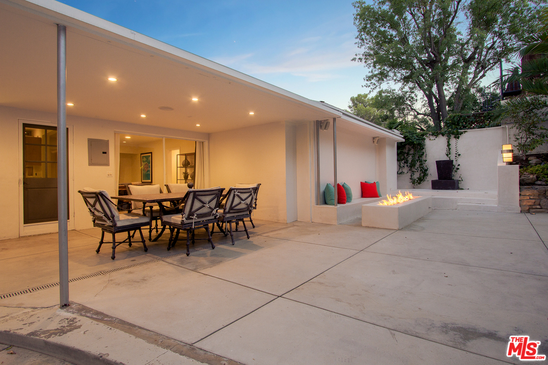 2267 Roscomare Road Los Angeles, CA 90077 - Photo 21 of 31 a view of a patio with dining table and chairs