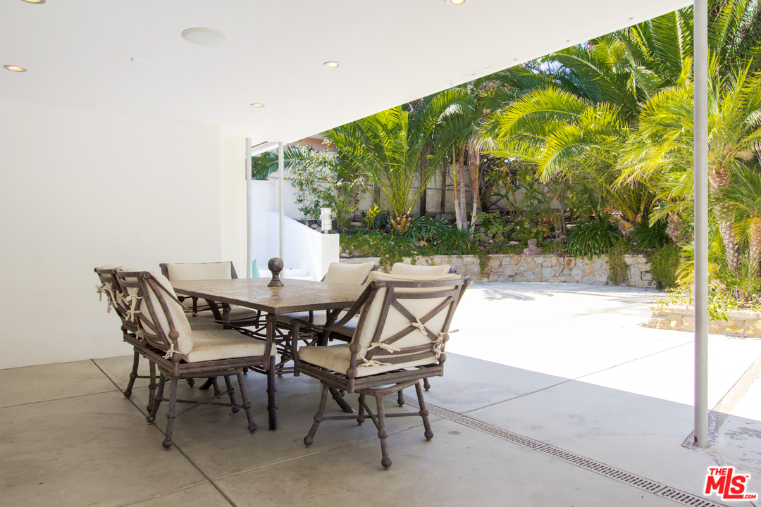 2267 Roscomare Road Los Angeles, CA 90077 - Photo 26 of 31 a view of an outdoor dining space with a table and chairs